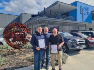 Founder and CEO Clem Rowe presents Francis Ford and Howard Kenworthy with 20 year service gifts.