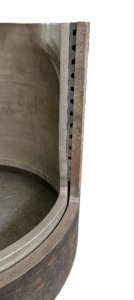 Cross-section of a hydroformed stainless-steel liner expanded against an existing well casing.